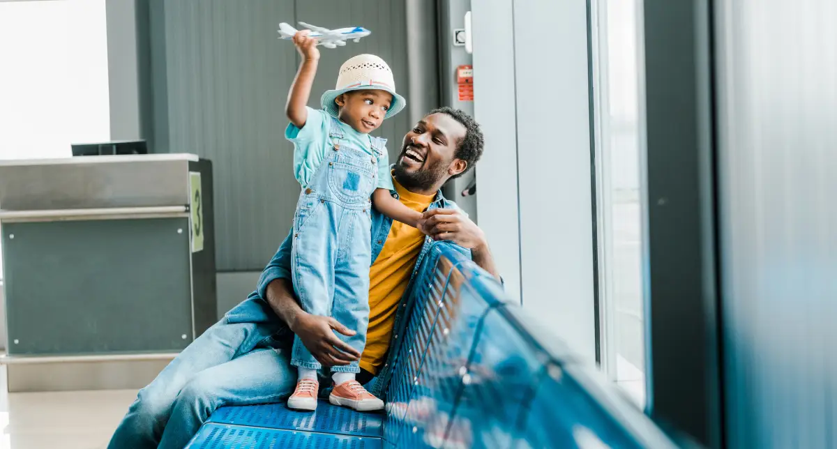 Father with his son waiting at airport for a flight to Portugal.