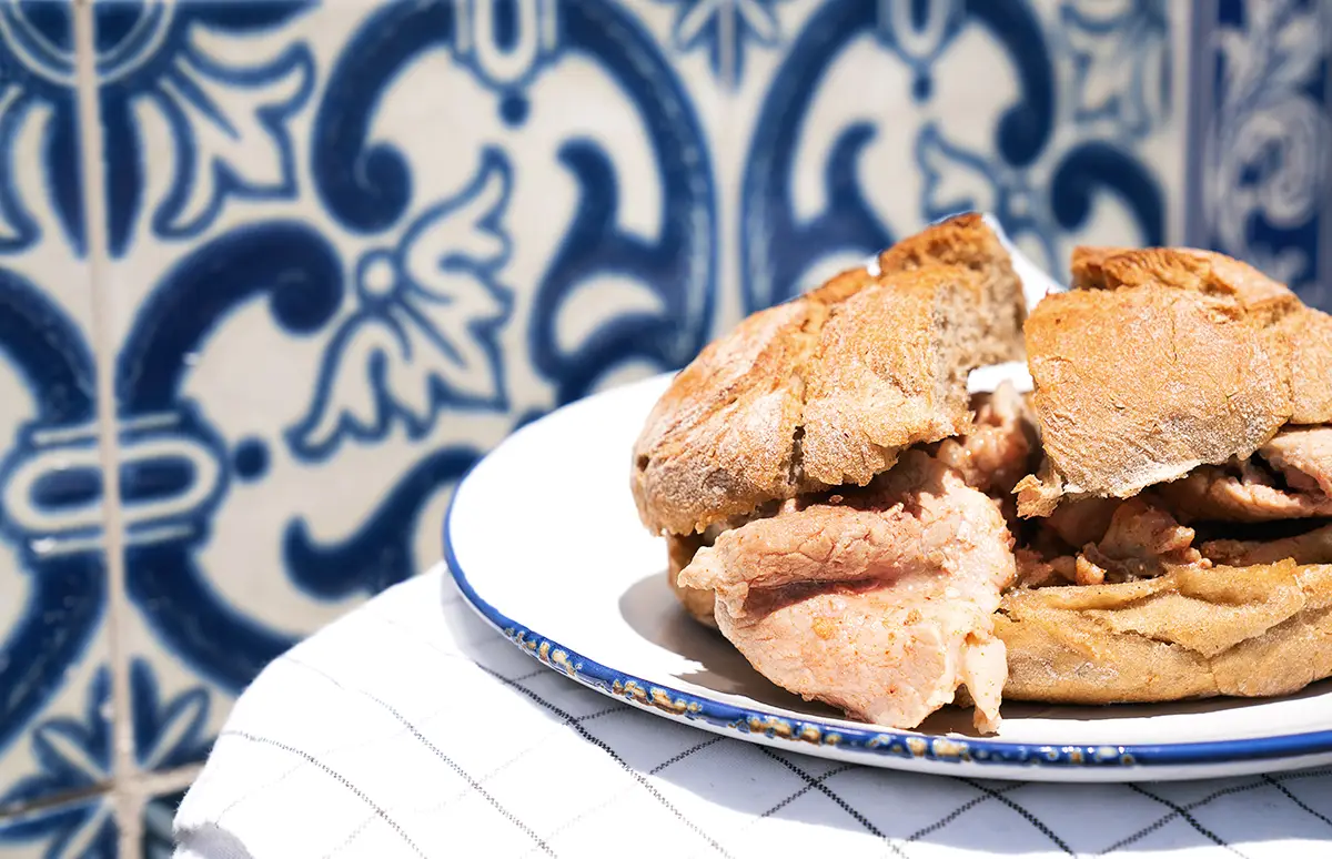 Bifanas are a Portuguese sandwich, a typical petisco containing pork or chicken with mustard sauce.