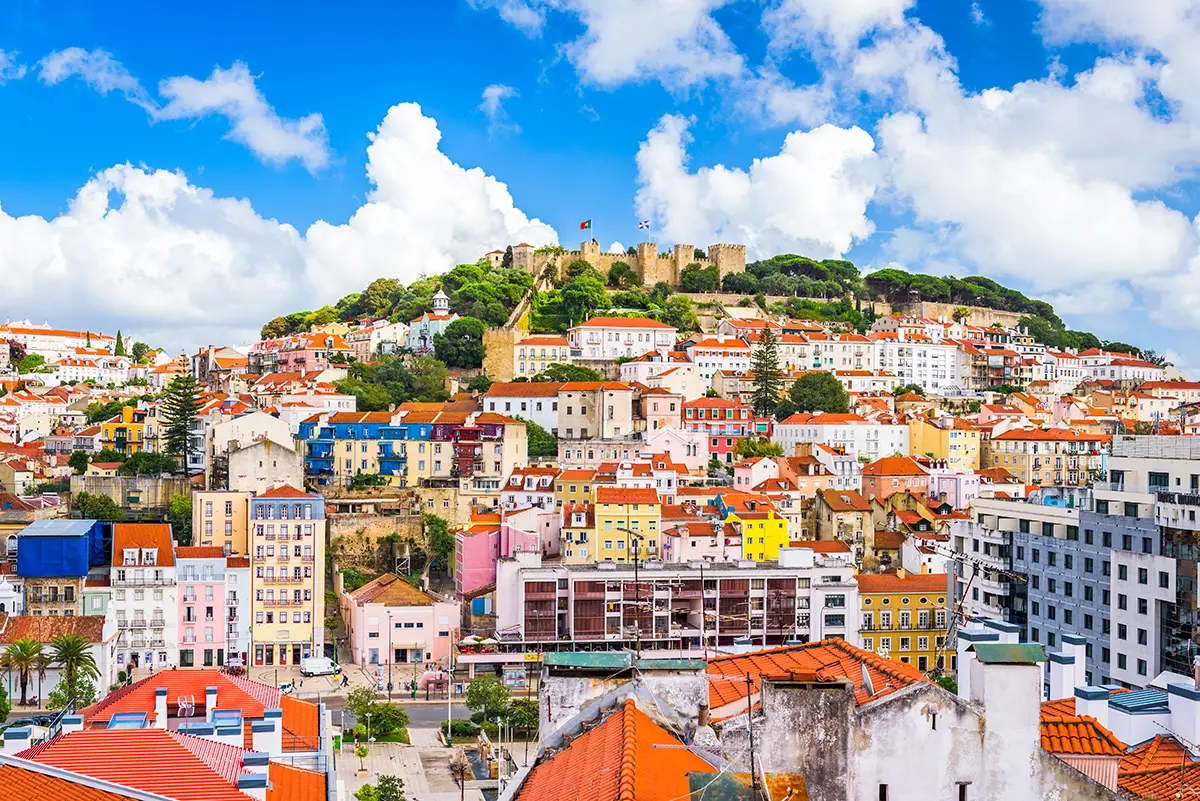 View of Lisbon's old town, one of Europe's most affordable capitals, with the São Jorge Castle at the top of the hill.