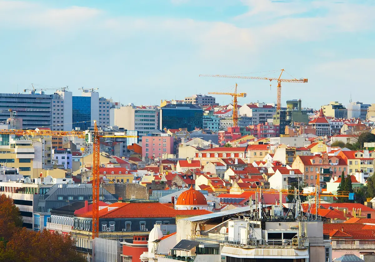 Landscape of crane constructions by building in the city centre of Lisbon.