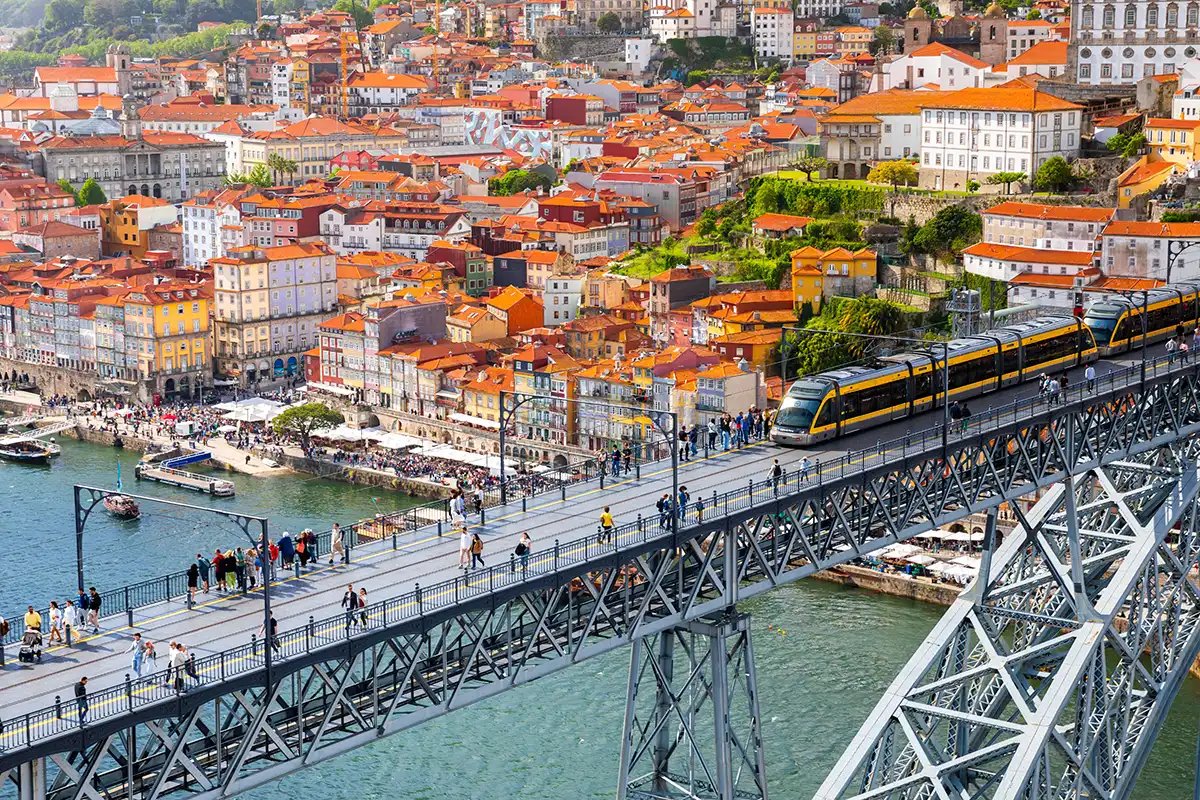 View of the Portugal's second-largest city, Porto, and its Douro riverside with the Luís I Bridge in the foreground.