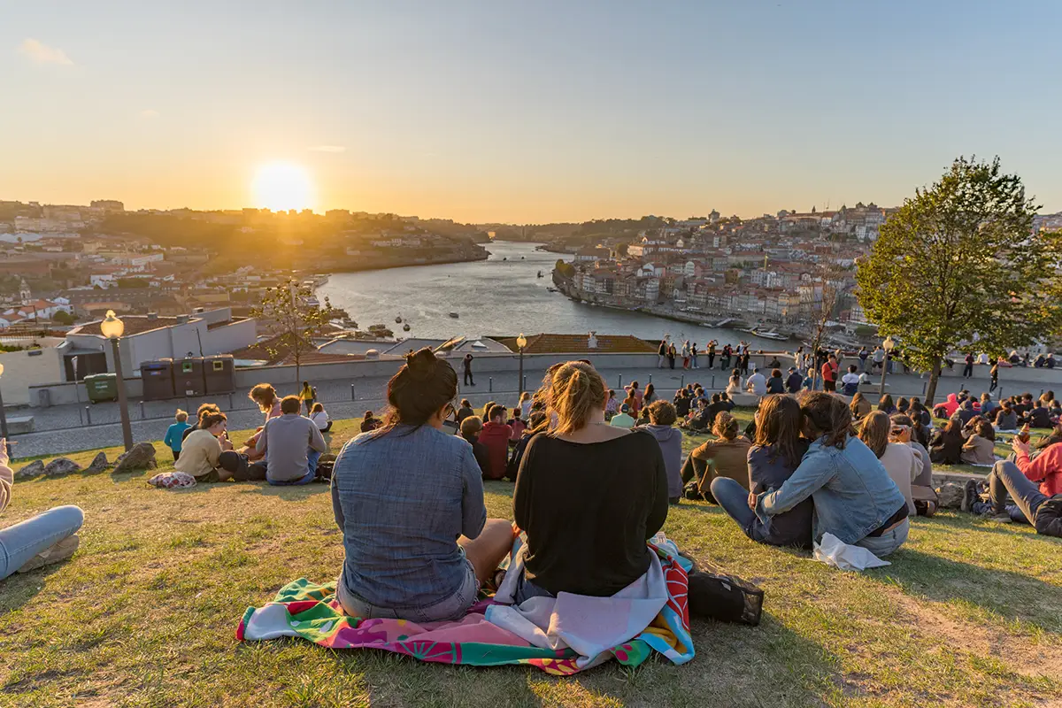 People admiring sunset in Porto.