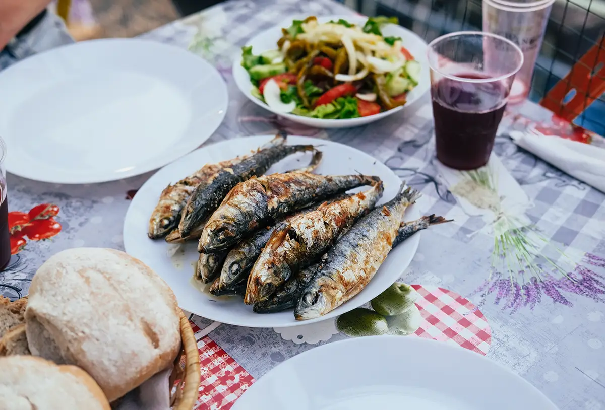 Sardines, one of the staples in Portuguese cuisine and the Santos Populares festivals, on a Portuguese table.